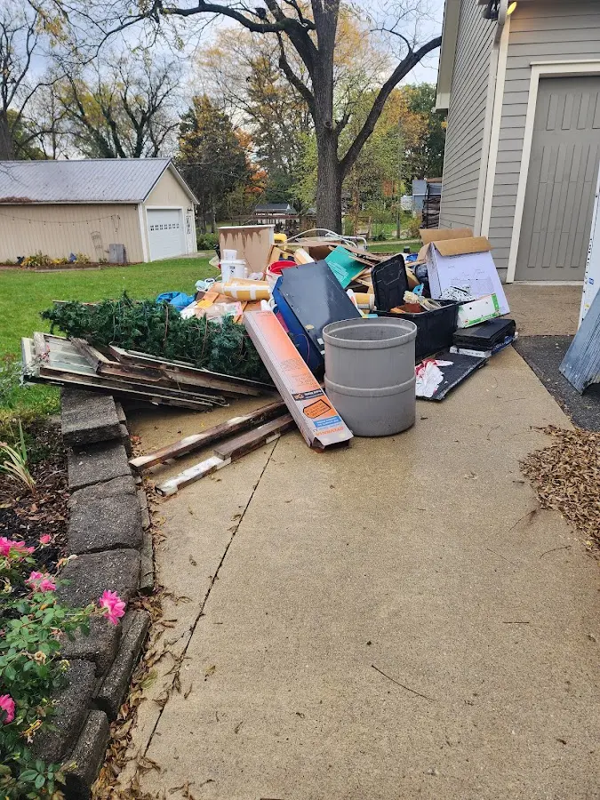 Dumpster being loaded with debris for Roofing Dumpster Rental in Newberry